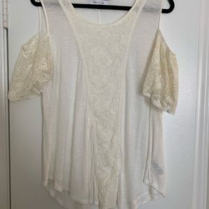 White shirt with shoulder cut outs.